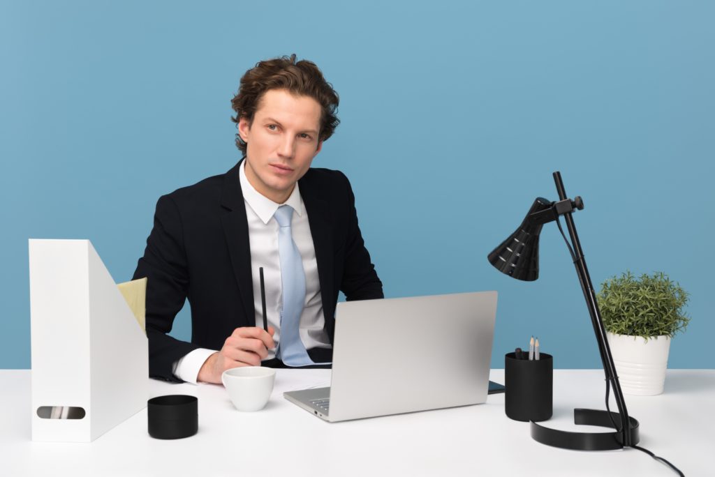 A man in a suit sitting at a desk