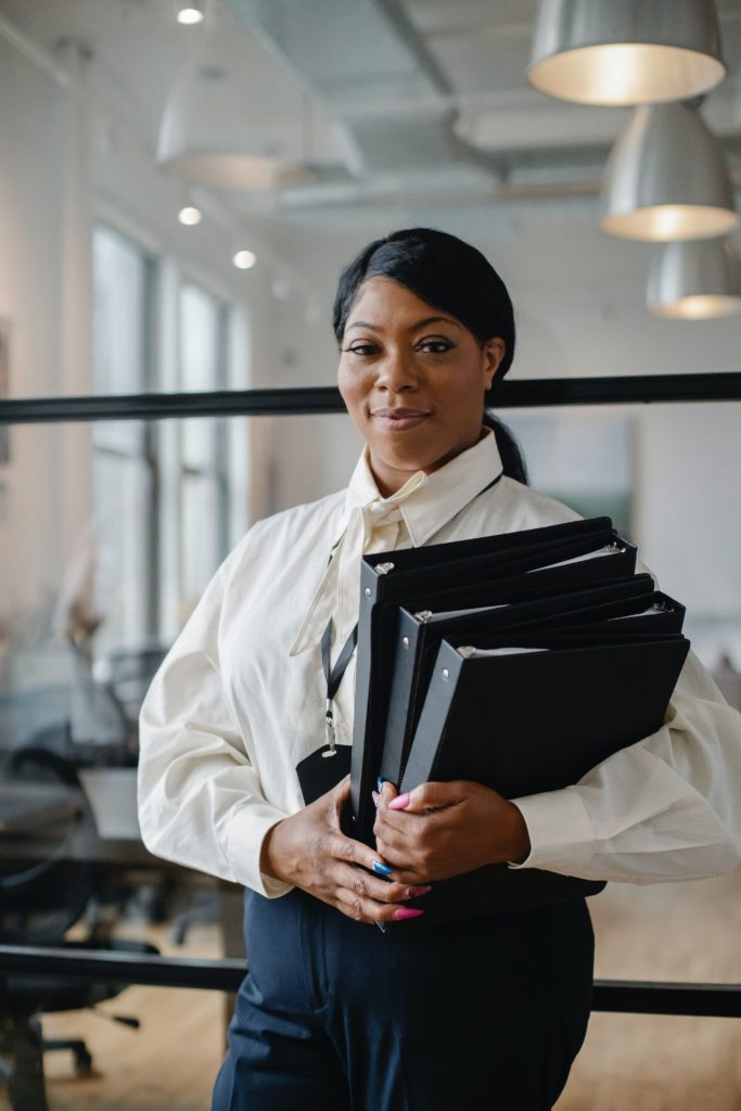 A woman carrying folders